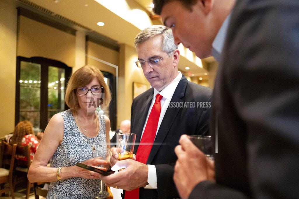 Ben Gray Incumbent Georgia Secretary of State Brad Raffensperger, checks returns with supporters during an election night party Tuesday evening, May 24, 2022, at a small restaurant in Peachtree Corners, Ga. (AP Photo/Ben Gray)