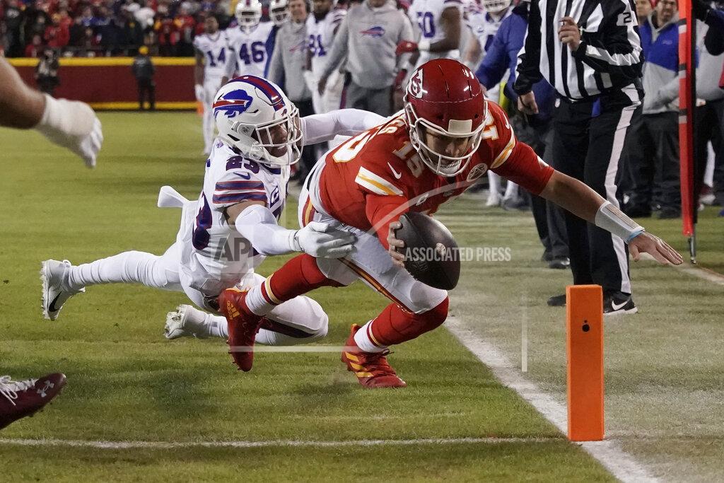 Charlie Riedel Kansas City Chiefs quarterback Patrick Mahomes (15) scores on an 8-yard touchdown run ahead of Buffalo Bills safety Micah Hyde (23) during the first half of an NFL divisional round playoff football game, Sunday, Jan. 23, 2022, in Kansas City, Mo. (AP Photo/Charlie Riedel)