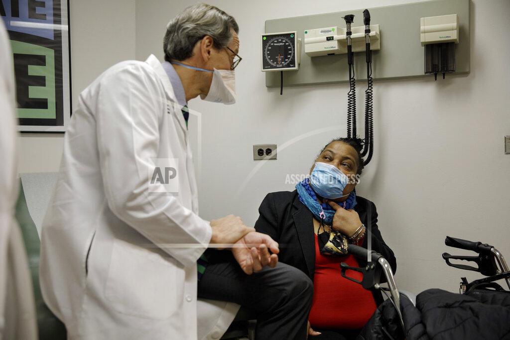 Trachea transplant recipient Sonia Sein talks with the lead surgeon of her procedure, Dr. Eric Genden, left, during a checkup visit at Mt. Sinai hospital in New York on Monday, March, 22, 2021. Sein says she had spent the last six years “trying to catch every breath at every moment" after extensive treatment for her severe asthma damaged her windpipe. But she is breathing freely again after a January windpipe transplant. (AP Photo/Marshall Ritzel)