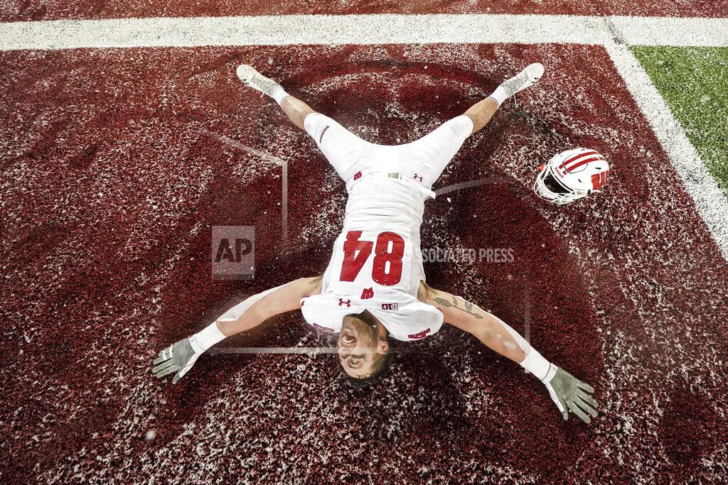Mark Vancleave Wisconsin tight end Jake Ferguson makes a snow angel after Wisconsin defeated Minnesota 38-17 during an NCAA college football game Saturday, Nov. 30, 2019, in Minneapolis. (Mark Vancleave/Star Tribune via AP)