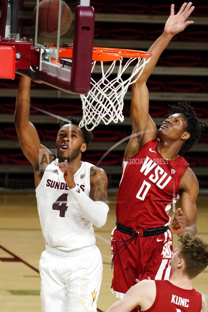 Rick Scuteri FILE - In this Saturday, Feb. 27, 2021 file photo, Arizona State forward Kimani Lawrence drives past Washington State center Efe Abogidi (0) during the first half of an NCAA college basketball game, in Tempe, Ariz. (AP Photo/Rick Scuteri, File)