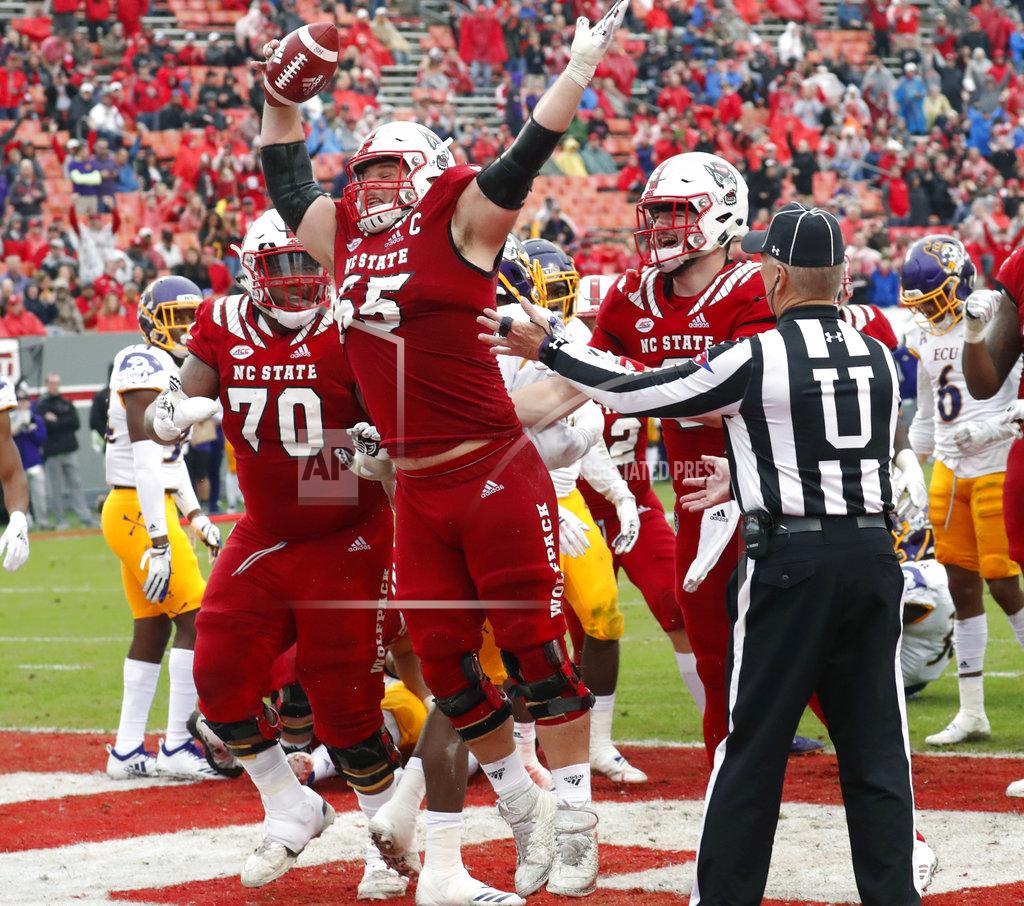 Chris Seward North Carolina State's Garrett Bradbury (65) celebrates after he scored a touchdown during the second half of NCAA college football game in Raleigh, N.C., Saturday, Dec. 1, 2018. (AP Photo/Chris Seward)