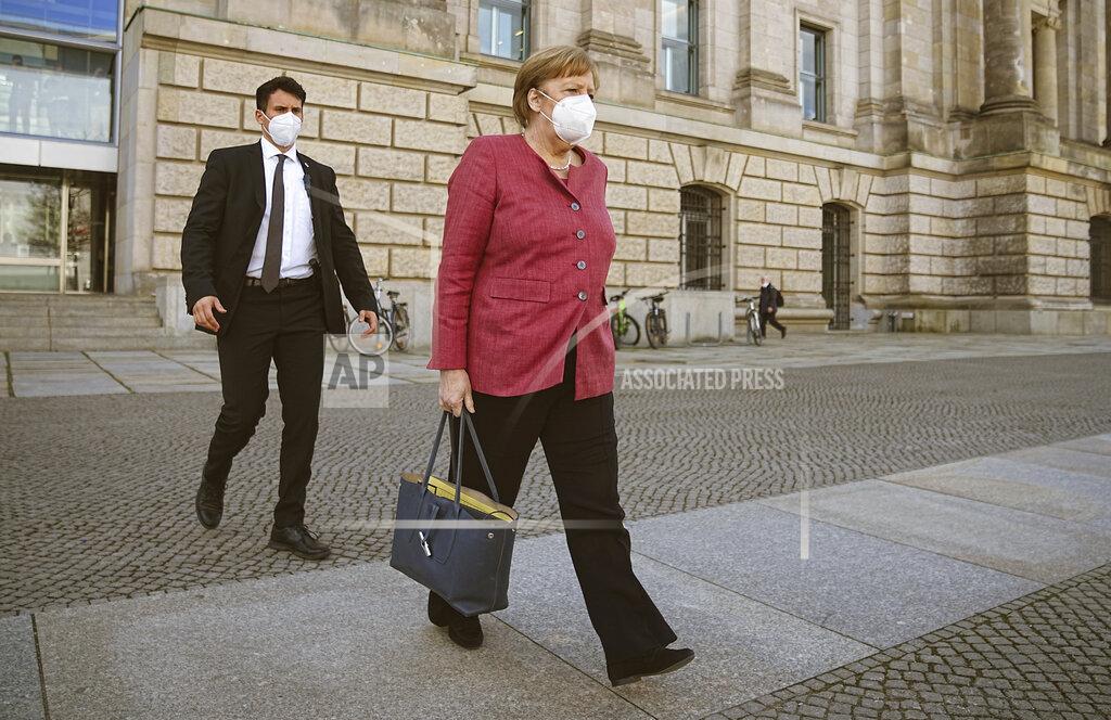 Michael Kappeler Chancellor Angela Merkel goes to her car after the session of the Bundestag in Berlin, Germany, Wednesday, April 21, 2021. The topic is the 2nd/3rd reading on the amendment of the Infection Protection Act, followed by a vote on the bill. (Michael Kappeler/dpa via AP)