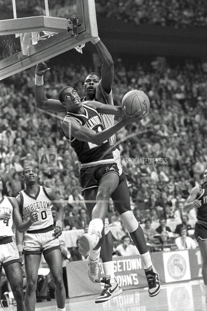 John Swart FILE - In this April 1, 1985, file photo, Villanova's Harold Pressley (21) goes up for a basket against Georgetown's Patrick Ewing in the NCAA college basketball Final Four championship game, in Lexington, Ky. Underdog Villanova, shooting 79 percent from the field, denied Patrick Ewing and top-ranked Georgetown a second straight NCAA basketball title Monday night with a 66-64 victory. (AP Photo/John Swart, File)