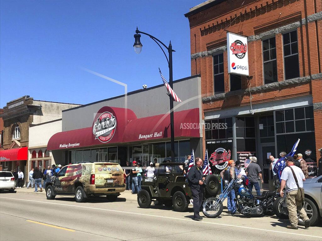 Kirsti Marohn A crowd gathers outside Shady's Hometown Tavern in Albany, Minn. on Monday, May 18, 2020. The owner told supporters outside his business that he's not opening his bar and grill Monday, on the advice of his attorney, after getting a call from Minnesota Attorney General Keith Ellison. (Kirsti Marohn/Minnesota Public Radio via AP)