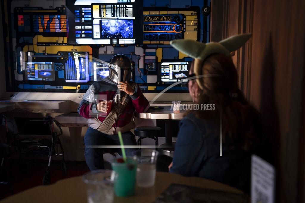 Jae C. Hong Two fans chat while celebrating the Star Wars Day at Scum and Villainy Cantina, a bar located on Hollywood Blvd, in Los Angeles, Tuesday, May 4, 2021. California has the lowest infection rate in the country. Los Angeles County, which is home to a quarter of the state's nearly 40 million people and has endured a disproportionate number of the state's 60,000 deaths, didn't record a single COVID-19 death Sunday or Monday, which was likely due to incomplete weekend reporting but still noteworthy. (AP Photo/Jae C. Hong)