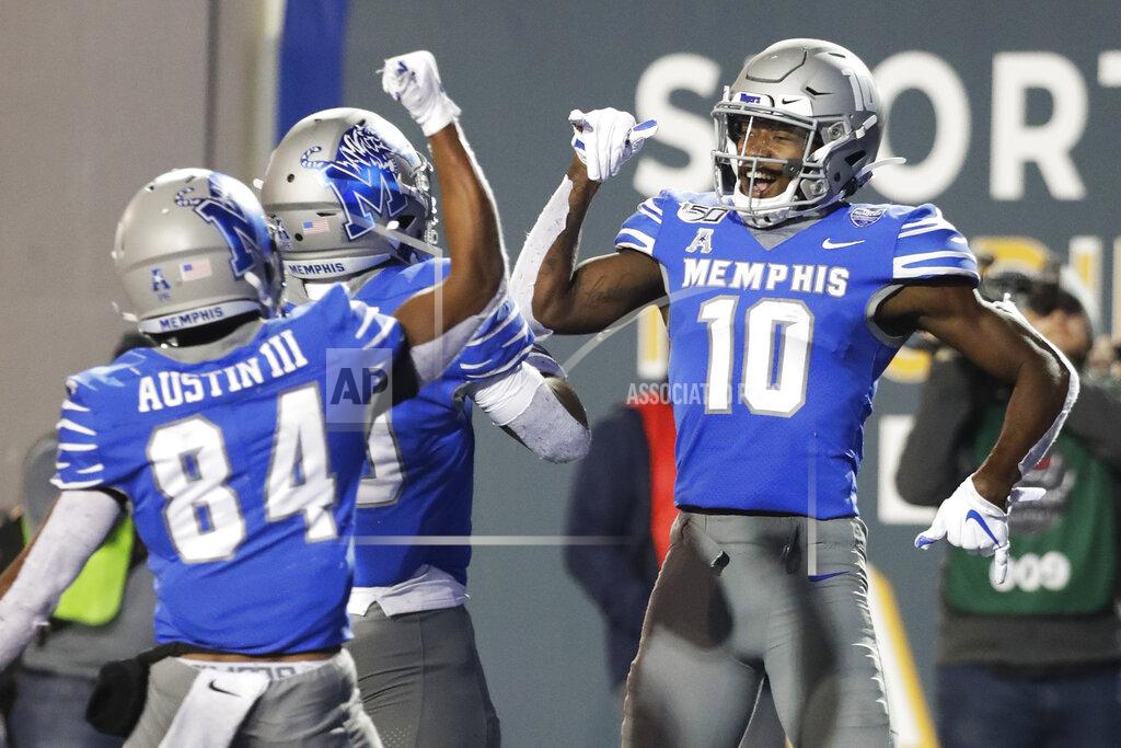Memphis wide receiver Damonte Coxie (10) celebrates with running back Kenneth Gainwell, center, and wide receiver Calvin Austin III (84) after Coxie caught a 49-yard touchdown pass against SMU during the second half of an NCAA college football game Saturday, Nov. 2, 2019, in Memphis, Tenn. Memphis won 54-48. (AP Photo/Mark Humphrey)