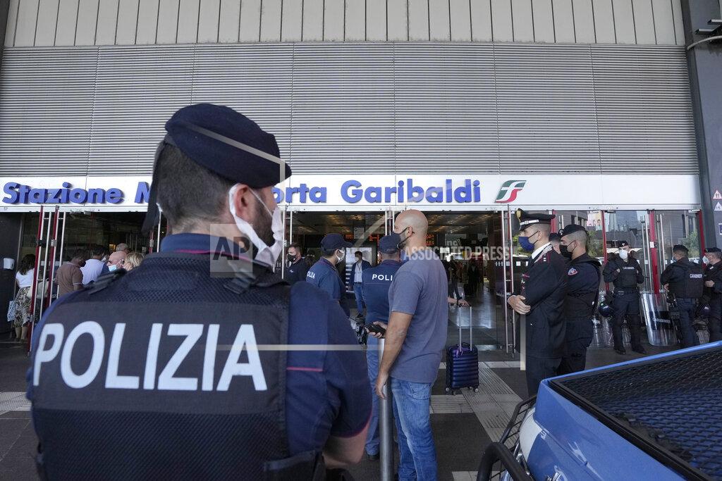 Luca Bruno Police officers stand guard at Porta Garibaldi train station, in Milan, Italy, Wednesday, Sept. 2, 2021. Italy's government vowed to crack down on demonstrators threatening to block train tracks throughout the country Wednesday as a rule requiring COVID-19 tests or vaccines to use public transportation for long-distance domestic travel took effect. (AP Photo/Luca Bruno)
