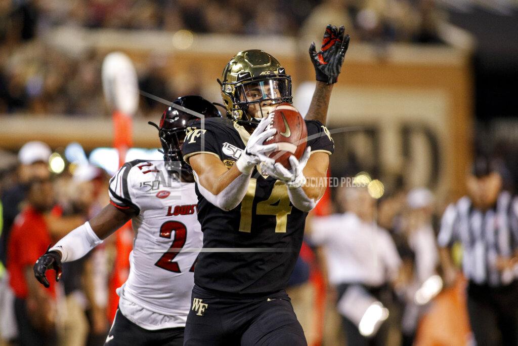 Nell Redmond Wake Forest wide receiver Sage Surratt, front, scores on a 47-yard reception against Louisville during the second half of an NCAA college football game in Winston-Salem, N.C., Saturday, Oct. 12, 2019. Louisville won 62-59. (AP Photo/Nell Redmond)