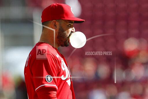 Cincinnati Reds' Eugenio Suarez blows a bubble while waiting for the next pitch against and Washington Nationals during the ninth inning of a baseball game Sunday, Sept. 26, 2021, in Cincinnati. The Reds defeated the Nationals 9-2. (AP Photo/Jay LaPrete)