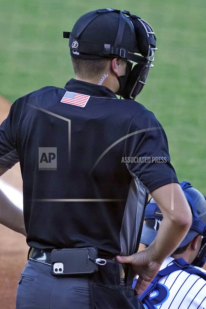 Chris O'meara Home plate umpire Kaleb Devier wears an earpiece and a battery pack during a Low A Southeast League baseball game between the Dunedin Blue Jays and the Tampa Tarpons at George M. Steinbrenner Field Tuesday, May 4, 2021, in Tampa, Fla. The game is one of the first in the league to use automatic balls and strike calls. (AP Photo/Chris O'Meara)
