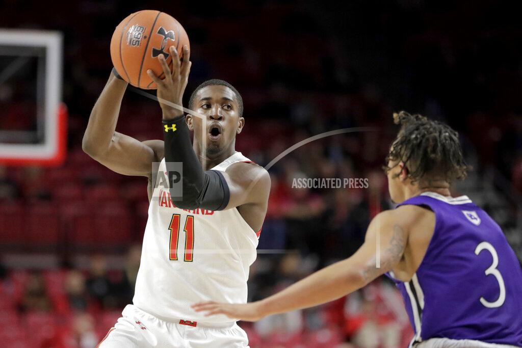 Julio Cortez Maryland guard Darryl Morsell (11) looks to pass against Holy Cross guard Drew Lowder (3) during the first half of an NCAA college basketball game, Tuesday, Nov. 5, 2019, in College Park, Md. (AP Photo/Julio Cortez)