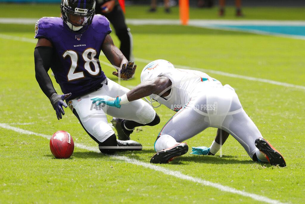 Wilfredo Lee Miami Dolphins wide receiver Jakeem Grant (19) drops a punt return as Baltimore Ravens defensive back Justin Bethel (28) attempts to grab it, during the first half at an NFL football game, Sunday, Sept. 8, 2019, in Miami Gardens, Fla. (AP Photo/Wilfredo Lee)