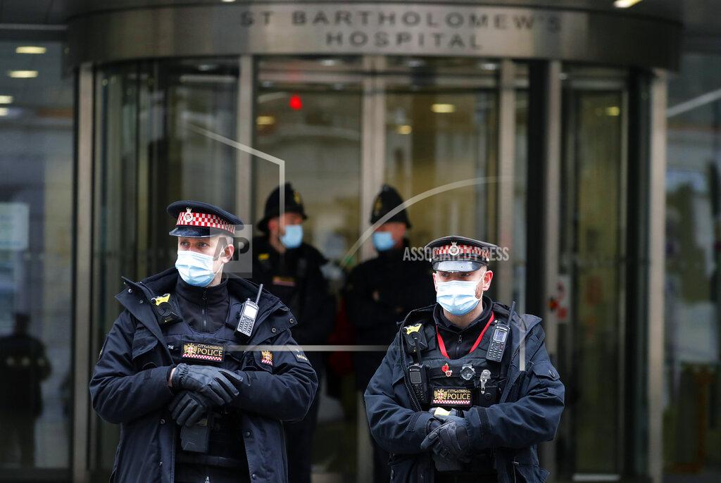 Frank Augstein Police officers stand outside the main entrance of St Bartholomew's Hospital where Britain's Prince Philip is being treated in London, Friday, March 5, 2021. Buckingham Palace says Prince Philip has had a successful heart procedure in a London hospital. The palace says the 99-year-old Duke of Edinburgh, the husband of Queen Elizabeth II, "underwent a successful procedure for a pre-existing heart condition at St Bartholomew's Hospital." (AP Photo/Frank Augstein)