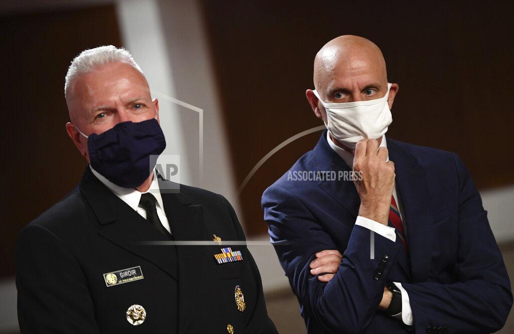 Kevin Dietsch Adm. Brett Giroir, left, director of the U.S. coronavirus diagnostic testing, and Food and Drug Administration (FDA) Commissioner Stephen Hahn, prepare to testify before a Senate Health, Education, Labor and Pensions Committee hearing on Capitol Hill in Washington, Tuesday, June 30, 2020. (Kevin Dietsch/Pool via AP)