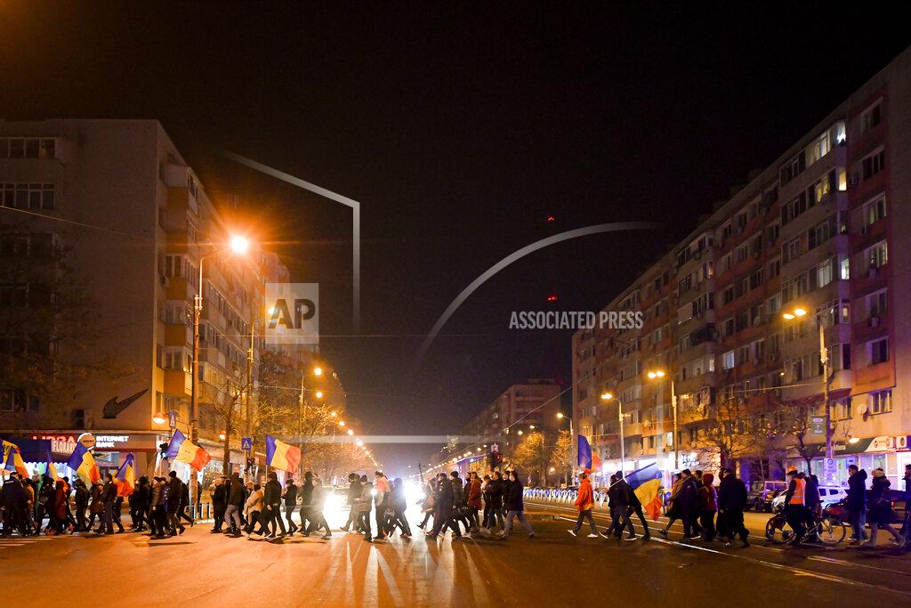 Andreea Alexandru Protesters waving flags march after a deadly fire at a hospital treating COVID-19 patients in Bucharest, Romania, Saturday, Jan. 30, 2021. Hundreds marched during a protest organized by the AUR alliance demanding the resignation of several top officials, after a fire early Friday at a key hospital in Bucharest that also treats COVID-19 patients killed five people. (AP Photo/Andreea Alexandru)