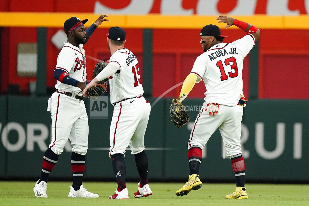 John Bazemore Atlanta Braves outfielders from left; Michael Harris II (23), Robbie Grossman (15), and Ronald Acuna Jr. (13) celebrate after defeating the New York Mets 5-0 in a baseball game Tuesday, Aug. 16, 2022, in Atlanta. (AP Photo/John Bazemore)