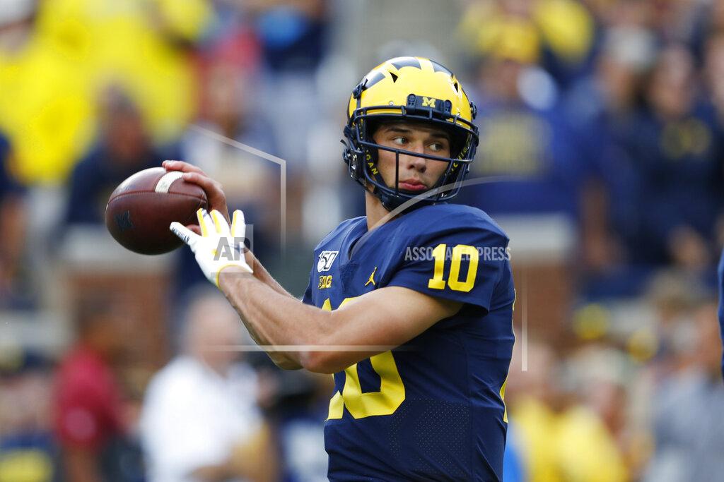 Paul Sancya FILE—In this Aug. 31, 2019, file photo, Michigan quarterback Dylan McCaffrey warms up for the team's NCAA college football game against Middle Tennessee in Ann Arbor, Mich. McCaffrey will play for Northern Colorado, team coached by his father, retired NFL wide receiver Ed McCaffrey, in the season ahead. (AP Photo/Paul Sancya, File)