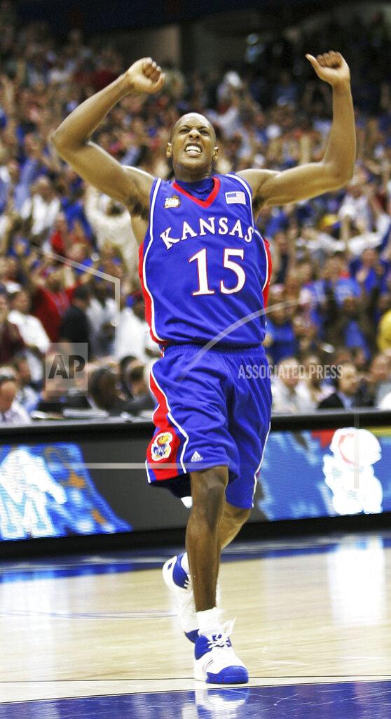Eric Gay FILE - In this April 7, 2008, file photo, Kansas' Mario Chalmers (15) celebrates after hitting a three point shot to take the game into overtime against Memphis during the championship game at the NCAA college basketball Final Four in San Antonio. Chalmers 3-pointer with 2.1 seconds left in regulation pushed the game into overtime, and the Jayhawks grinded it out from there for a 75-68 victory over Memphis in one of the best title games in recent memory. (AP Photo/Eric Gay), File