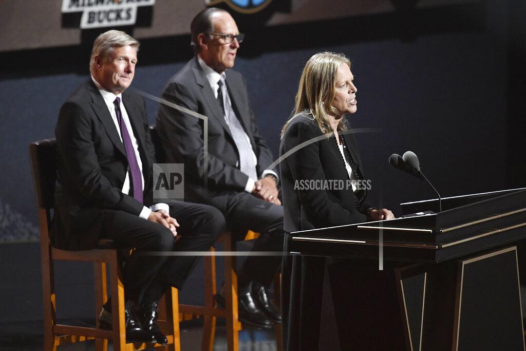 Jessica Hill Inductee Val Ackerman, speaks as presenters Rick Welts, left, and Russ Granik listen during the 2021 Basketball Hall of Fame Enshrinement ceremony, Saturday, Sept. 11, 2021, in Springfield, Mass. (AP Photo/Jessica Hill)