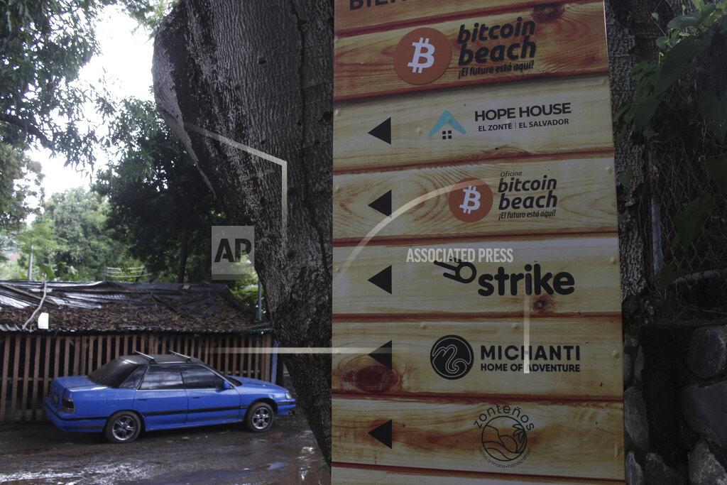 Salvador Melendez A sign that advertises the acceptance of cryptocurrencies at local businesses stands at one of the entrances of Zonte Beach in Tamanique, El Salvador, Wednesday, June 9, 2021. El Salvador's Legislative Assembly has approved legislation making the cryptocurrency Bitcoin legal tender in the country, the first nation to do so, just days after President Nayib Bukele made the proposal at a Bitcoin conference. (AP Photo/Salvador Melendez)