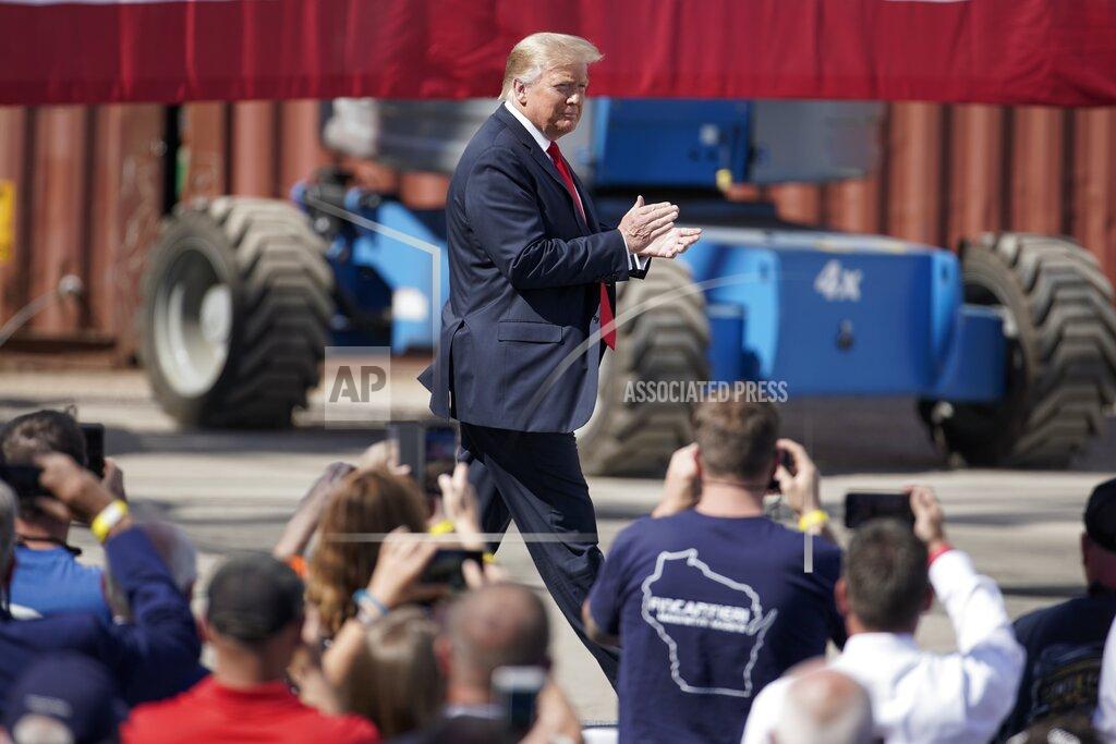 Morry Gash President Donald Trump walks on stage before speaking at an event at Fincantieri Marinette Marine, Thursday, June 25, 2020, in Marinette, Wis. (AP Photo/Morry Gash)