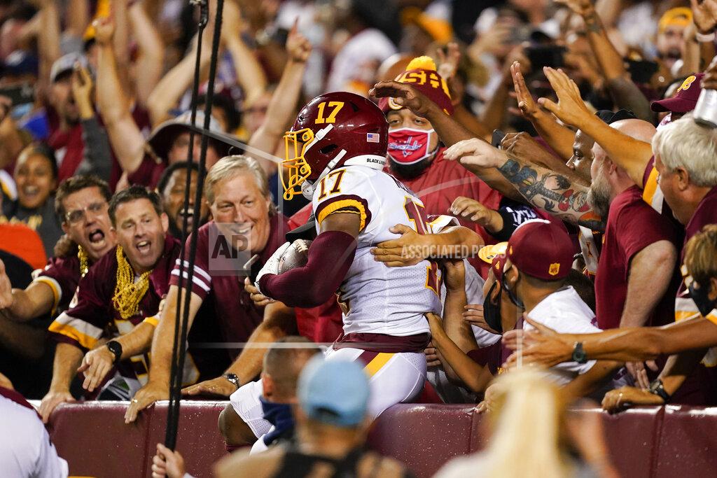 Alex Brandon Washington Football Team wide receiver Terry McLaurin (17) jumps into the stands to celebrate his touchdown catch against the New York Giants during the first half of an NFL football game, Thursday, Sept. 16, 2021, in Landover, Md. (AP Photo/Alex Brandon)