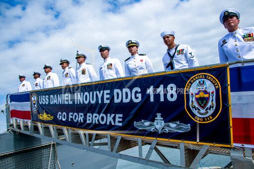 After manning the ship, officers stand on the gangway during the commissioning ceremony for the USS Daniel Inouye, named after the long-serving U.S. senator from Hawaii and decorated World War II veteran, at Pearl Harbor, Hawaii on Wednesday, Dec. 8, 2021. (Craig T. Kojima/Honolulu Star-Advertiser via AP)