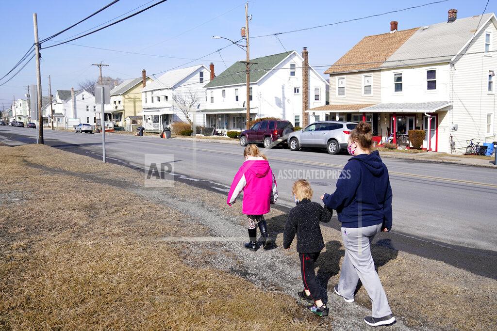 Matt Slocum From right, Melissa Weirich, walks with her son, Julien Heim, 4, and daughter, Kacie Thompson, 9, to visit the former home of Kacie's friend, Ava Lerairo, Thursday, March 11, 2021, in Lansford, Pa. On May 26, 2020, Ava; her mother, Ashley Belson, and Ava's father, Marc Lerario were found fatally shot. (AP Photo/Matt Slocum)