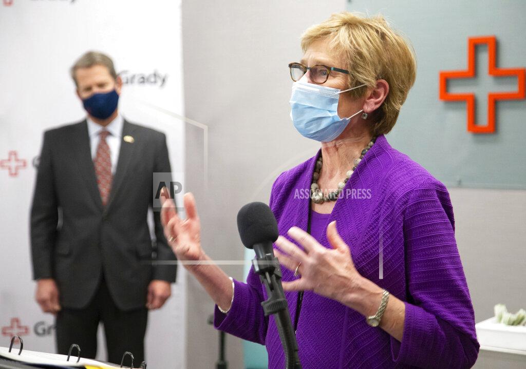 Steve Schaefer Dr. Kathleen Toomey provides updates on COVID-19 in Georgia during a press conference at Grady Hospital, Thursday, Dec. 17, 2020, in Atlanta. Looking on is Georgia Gov. Brian Kemp. (Steve Schaefer/Atlanta Journal-Constitution via AP)