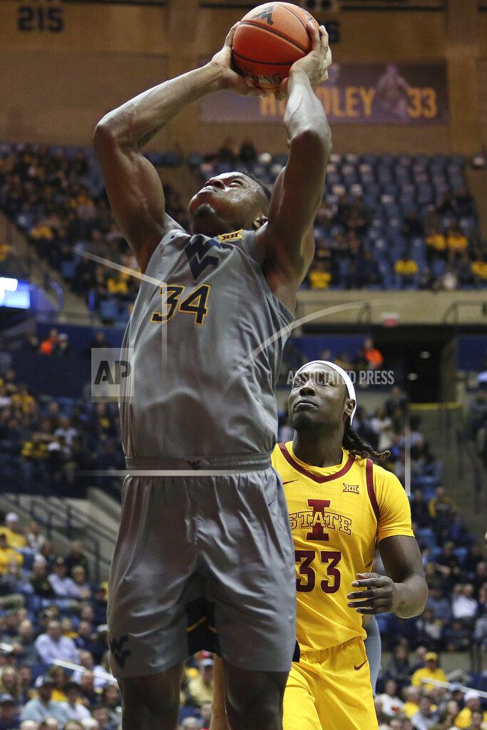 Kathleen Batten West Virginia forward Oscar Tshiebwe (34) shoots as he is defended by Iowa State forward Solomon Young (33) during the second half of an NCAA college basketball game Wednesday, Feb. 5, 2020, in Morgantown, W.Va. (AP Photo/Kathleen Batten)