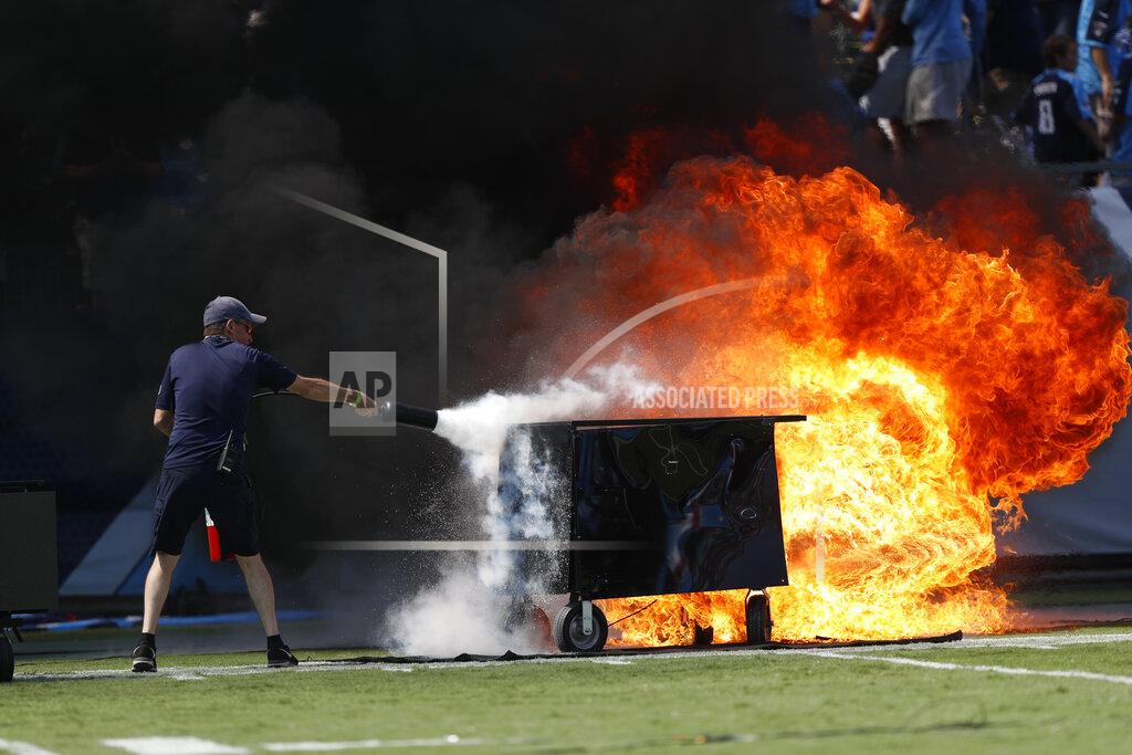 Wade Payne A fire from a pyrotechnics machine is extinguished before an NFL football game between the Tennessee Titans and the Indianapolis Colts Sunday, Sept. 15, 2019, in Nashville, Tenn. (AP Photo/Wade Payne)