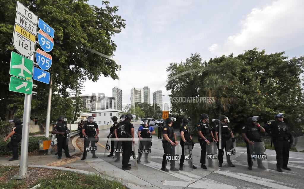 Wilfredo Lee A line of City of Miami police officers block a ramp for Interstate 95 as protesters march against the death of George Floyd, Sunday, May 31, 2020, in Miami. Floyd died after being restrained by Minneapolis police officers on May 25. (AP Photo/Wilfredo Lee)