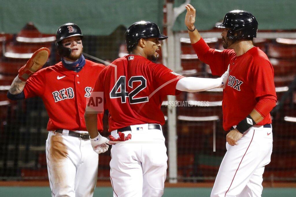 Michael Dwyer Boston Red Sox's Xander Bogaerts, center, celebrates his three-run home run that also drove in Alex Verdugo, left, and J.D. Martinez during the first inning of a baseball game against the Washington Nationals, Saturday, Aug. 29, 2020, in Boston. (AP Photo/Michael Dwyer)