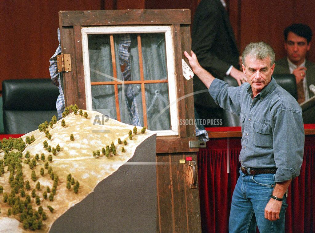 Joe Marquette FILE - In this Sept. 6, 1995, file photo, Randy Weaver holds the door of his cabin showing holes from bullets fired during the 1992 siege of his Ruby Ridge, Idaho, home, model at left, during testimony before the Senate Judiciary Subcommittee on Capitol Hill in Washington. The standoff in the remote mountains of northern Idaho left a 14-year-old boy, his mother and a federal agent dead and sparked the expansion of radical right-wing groups across the country. (AP Photo/Joe Marquette, File)