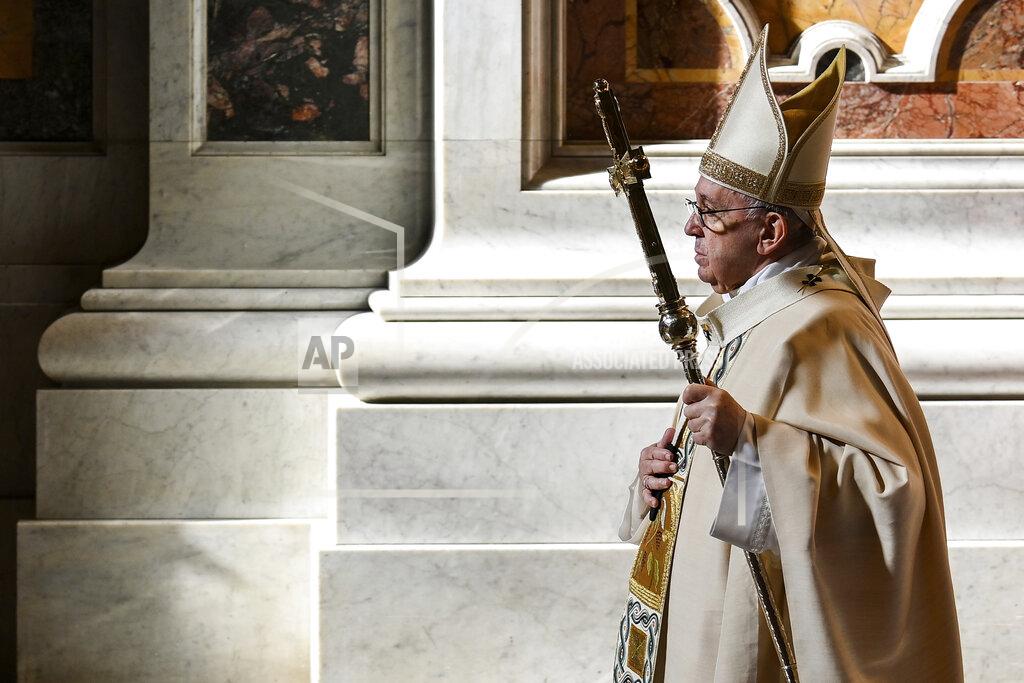 Pope Francis leaves after celebrating Mass on the occasion of the Christ the King festivity, in St. Peter's Basilica at the Vatican, Sunday, Nov. 22, 2020. At the end of the mass a delegation of youths from Panama will hand over the World Youth Day cross to youths from Portugal, where the next World Youth Day will be held in 2023. (Vincenzo Pinto/Pool via AP)