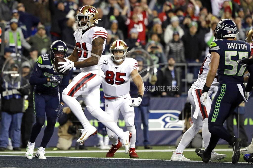 Ted S. Warren San Francisco 49ers' Raheem Mostert scores a touchdown against the Seattle Seahawks during the second half of an NFL football game, Sunday, Dec. 29, 2019, in Seattle. (AP Photo/Ted S. Warren)