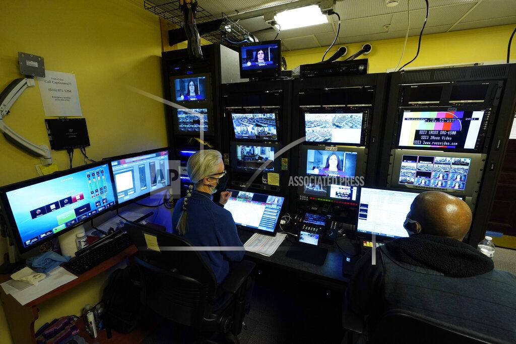 Steve Helber Virginia Public Media techs, Roberta Fallon, left, and Phillip Newsome, right, monitor the video feeds during a Virginia House of Delegates Zoom Legislative session at the Capitol in Richmond, Va., Wednesday, Feb. 10, 2021. (AP Photo/Steve Helber)