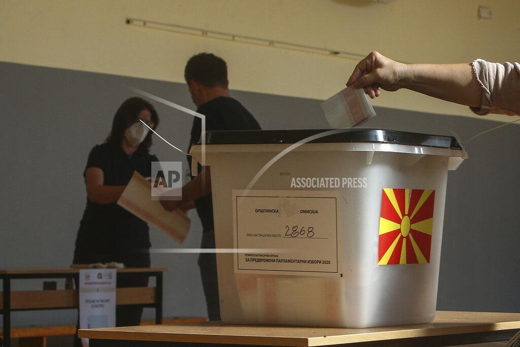 Boris Grdanoski A woman casts her ballot at a polling station in Skopje, North Macedonia on Wednesday, July 15, 2020. Voters in North Macedonia were heading to polls early on Wednesday in the country's general election despite an alarming spike in coronavirus cases in the tiny Balkan nation. (AP Photo/Boris Grdanoski)