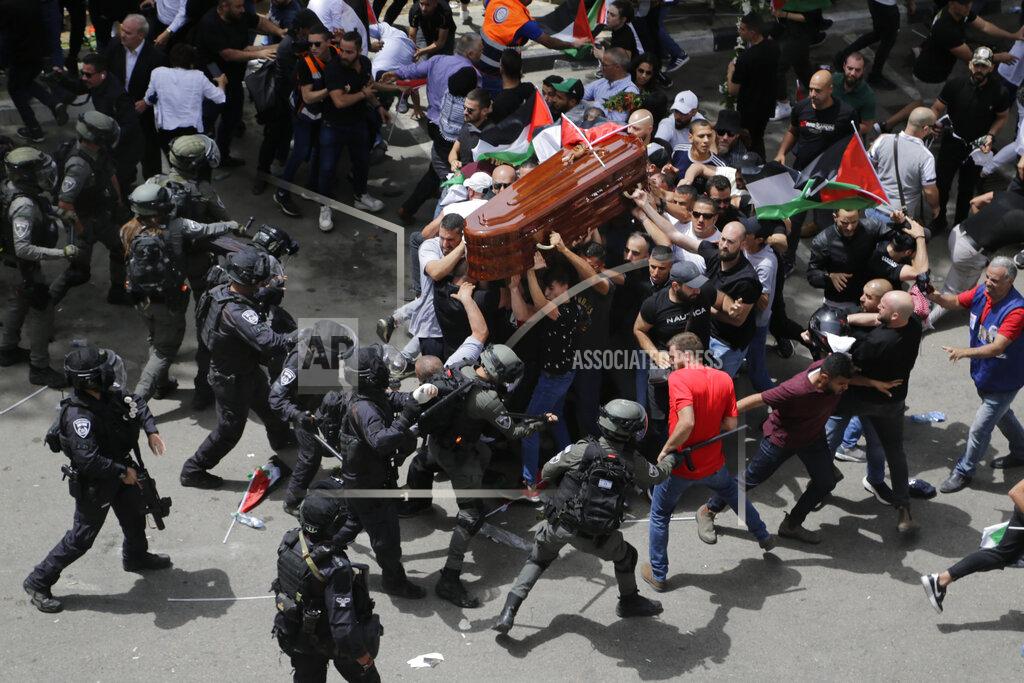 Maya Levin Israeli police confront with mourners as they carry the casket of slain Al Jazeera veteran journalist Shireen Abu Akleh during her funeral in east Jerusalem, Friday, May 13, 2022. Abu Akleh, a Palestinian-American reporter who covered the Mideast conflict for more than 25 years, was shot dead Wednesday during an Israeli military raid in the West Bank town of Jenin. (AP Photo/Maya Levin)