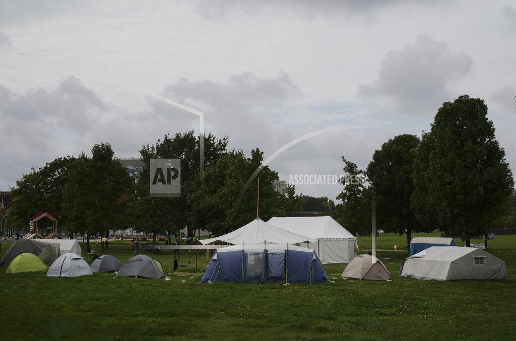 Markus Schreiber A small camp of climate activists is set up near the chancellary, background behind the trees, in Berlin, Wednesday, Sept. 22, 2021. In the camp climate activists on a hunger strike and hope to pressure candidates for chancellor of Germany into meeting them for a debate about the climate crisis ahead Sunday's general election. For the first time in Germany's history, climate change is a central issue of an election campaign, overwhelmingly so for the young generation.(AP Photo/Markus Schreiber)