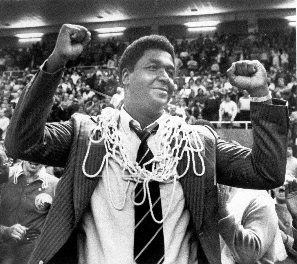Anestis Diakopoulos FILE - In this March 1, 1980, file photo, Georgetown University basketball coach John Thompson raises his hands in victory after fans placed the net around his neck in Providence, R.I., after Georgetown defeated Syracuse University 87-81 to win the Big East basketball championship. John Thompson, the imposing Hall of Famer who turned Georgetown into a “Hoya Paranoia” powerhouse and became the first Black coach to lead a team to the NCAA men’s basketball championship, has died. He was 78 His death was announced in a family statement Monday., Aug. 31, 2020. No details were disclosed.(Anestis Diakopoulos/Providence Journal via AP, FIle)