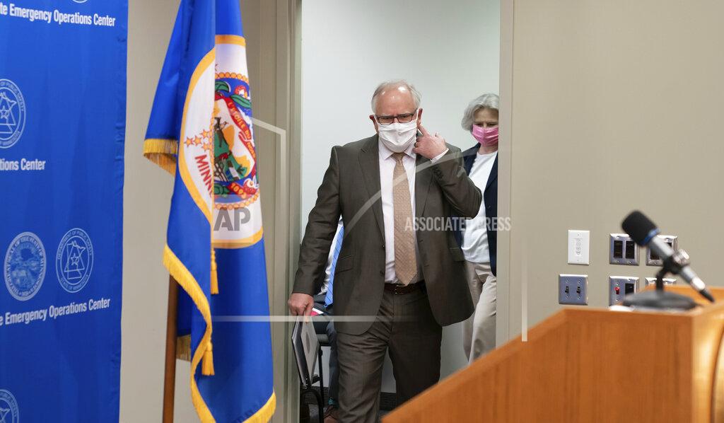 Glen Stubbe Minnesota Governor Tim Walz arrives to speak at a news conference about the state's response to the coronavirus outbreak Wednesday, May 20, 2020. Restaurants and bars may reopen June 1 for outdoor dining with social distancing and other safeguards in place, while salons and barbershops will also be allowed to resume business at partial capacity. (Glen Stubbe/Star Tribune via AP, Pool)