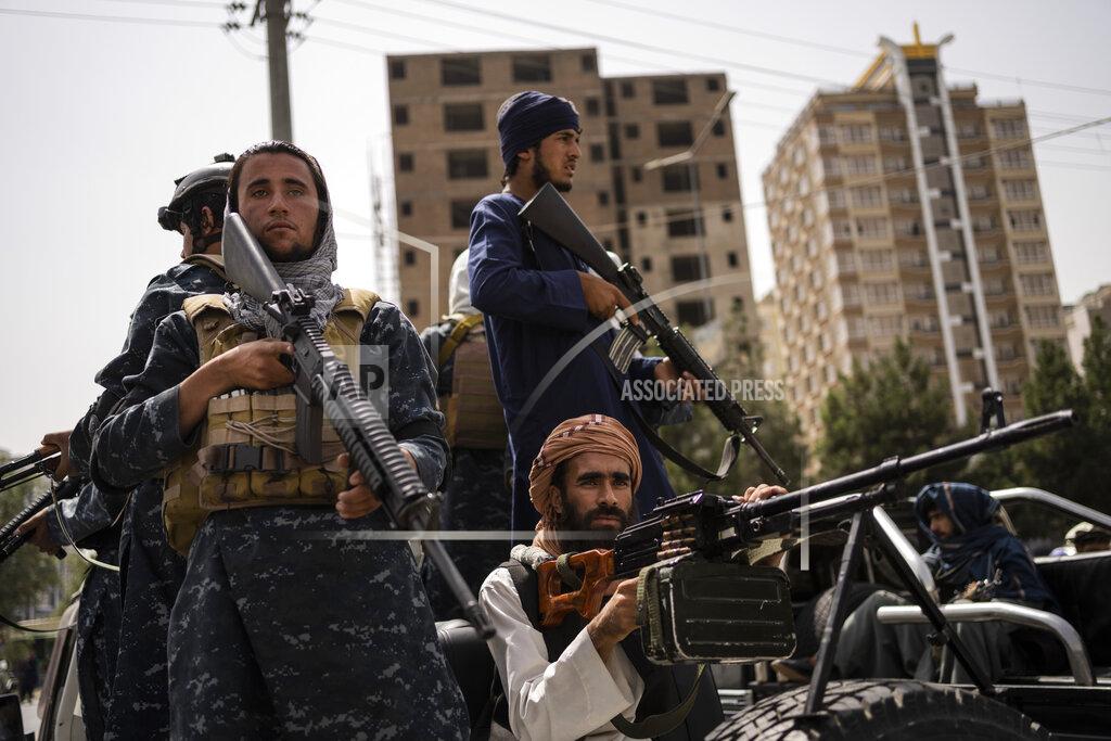 Bernat Armangue Taliban fighters escort women march in support of the Taliban government outside Kabul University, Afghanistan, on Saturday, Sept. 11, 2021. (AP Photo/Bernat Armangue)