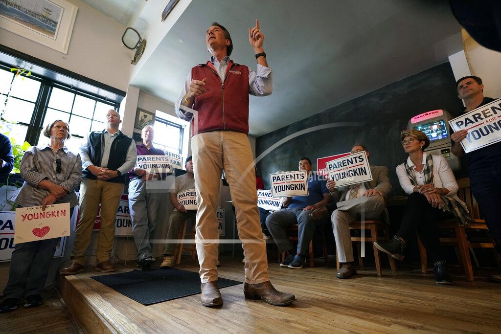 Steve Helber Virginia Republican gubernatorial candidate Glenn Youngkin, left, gestures a he talks with supporters during a rally in Culpeper, Va., Wednesday, Oct. 13, 2021. Youngkin faces former Gov. Terry McAuliffe in the November election. (AP Photo/Steve Helber)