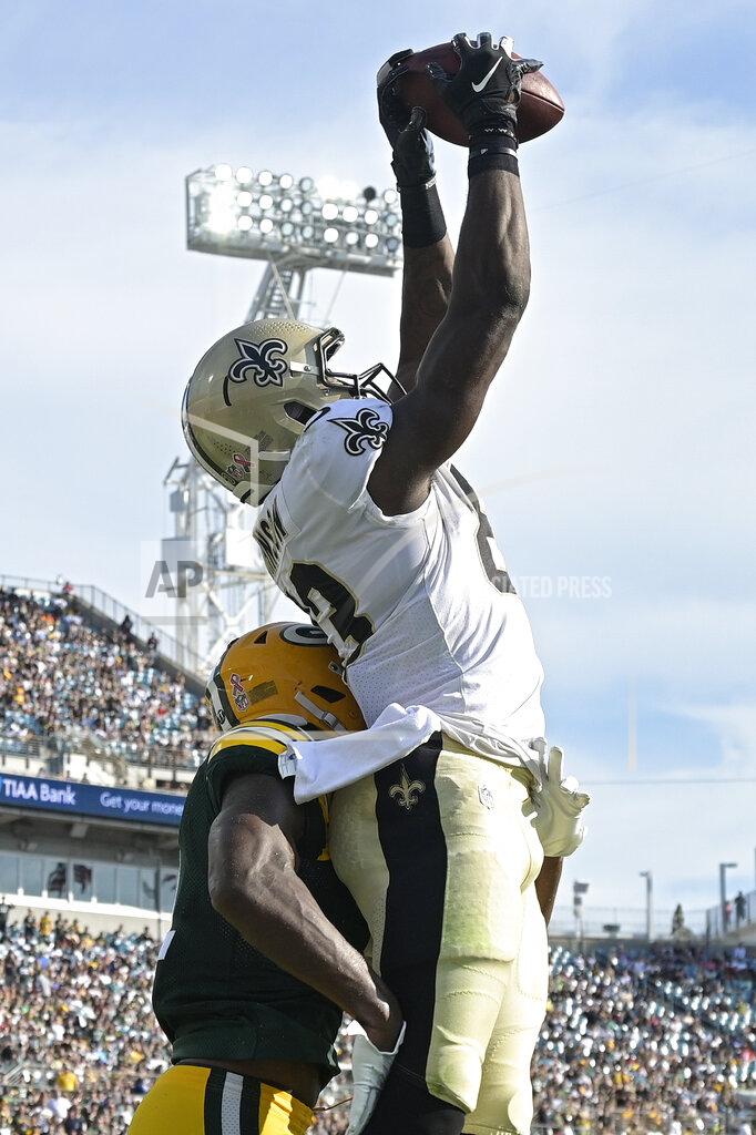 Phelan M. Ebenhack New Orleans Saints tight end Juwan Johnson, right, reaches up for a touchdown reception over Green Bay Packers strong safety Adrian Amos, left, during the first half of an NFL football game, Sunday, Sept. 12, 2021, in Jacksonville, Fla. (AP Photo/Phelan M. Ebenhack)