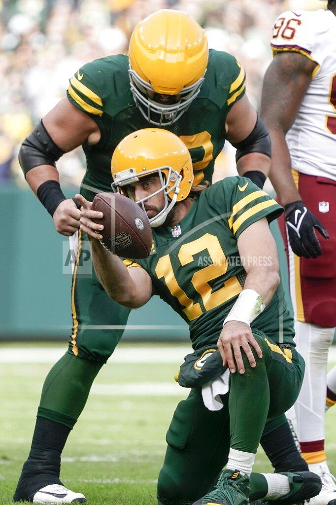 Morry Gash Green Bay Packers' Aaron Rodgers celebrates his first down run with Lucas Patrick during the first half of an NFL football game against the Washington Football Team Sunday, Oct. 24, 2021, in Green Bay, Wis. (AP Photo/Morry Gash)