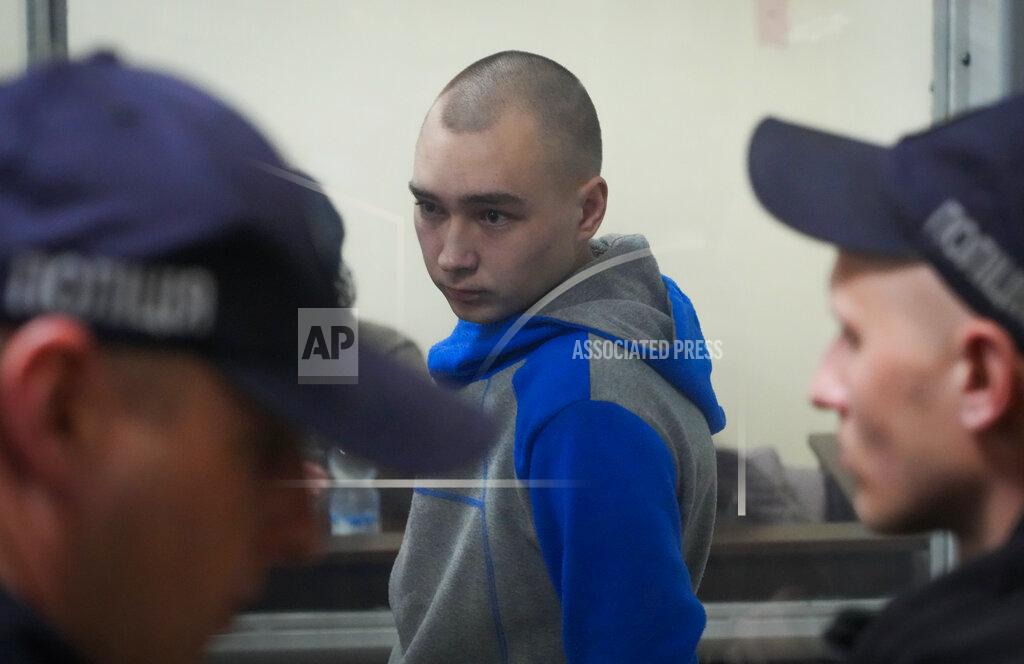 Efrem Lukatsky Russian army Sergeant Vadim Shishimarin, 21, is seen behind a glass during a court hearing in Kyiv, Ukraine, Wednesday, May 18, 2022. The Russian soldier has gone on trial in Ukraine for the killing of an unarmed civilian. The case that opened in Kyiv marked the first time a member of the Russian military has been prosecuted for a war crime since Russia invaded Ukraine 11 weeks ago. (AP Photo/Efrem Lukatsky)