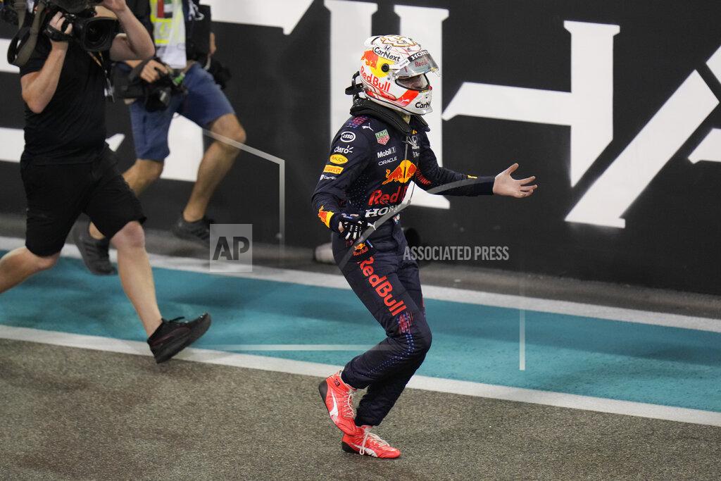 Hassan Ammar Red Bull driver Max Verstappen of the Netherlands celebrates after he became the world champion after winning the Formula One Abu Dhabi Grand Prix in Abu Dhabi, United Arab Emirates, Sunday, Dec. 12, 2021. (AP Photo/Hassan Ammar)