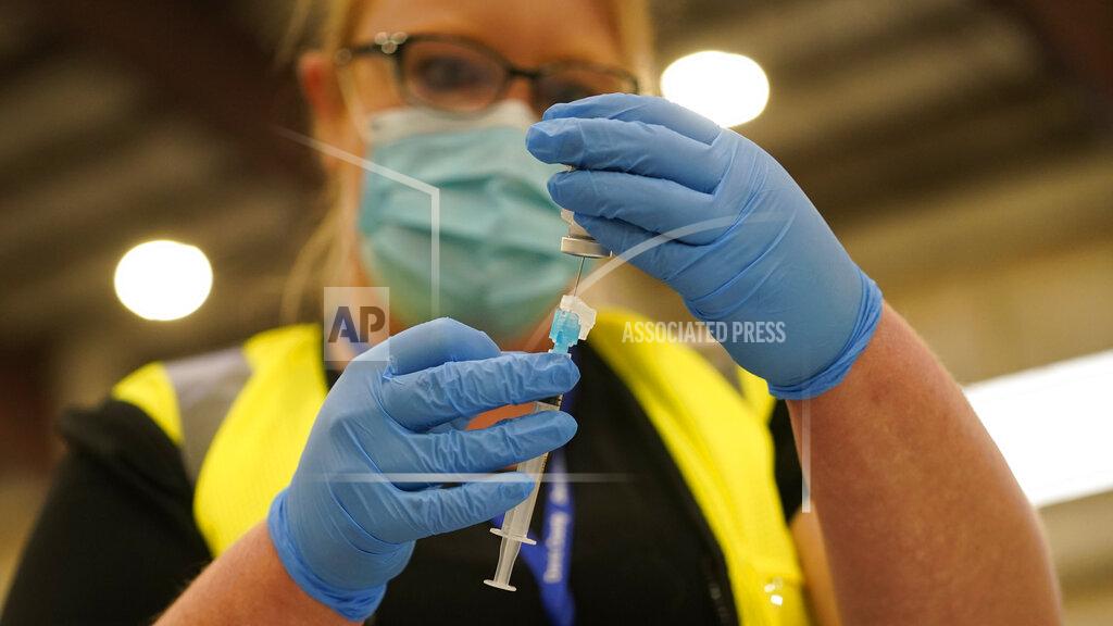 Rick Bowmer Registered nurse Lindsey Meyer prepares to administer the COVID-19 vaccine at the Davis County Legacy Center Tuesday, Jan. 12, 2021, in Farmington, Utah. Utah began vaccinating teachers and school staff across the state. They are aiming to have all teachers and school staff vaccinated by the end of February. (AP Photo/Rick Bowmer)